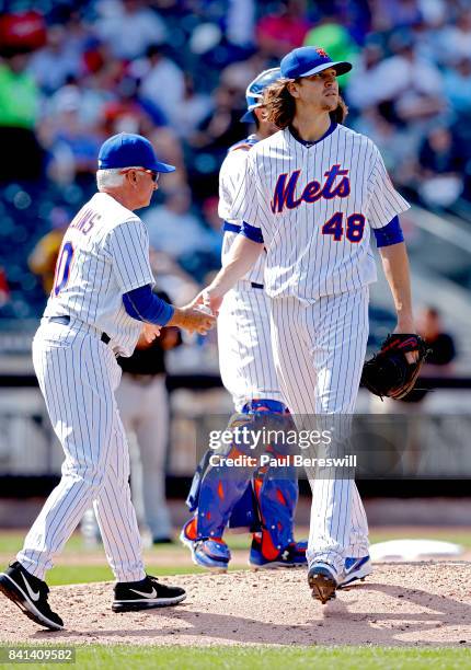 Pitcher Jacob deGrom of the New York Mets hands the ball to manager Terry Collins of the Mets as he is removed from an MBL baseball game against the...