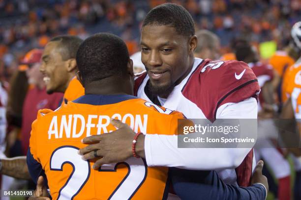 Denver Broncos running back CJ Anderson hugs Arizona Cardinals running back David Johnson after the Arizona Cardinals vs. Denver Broncos game on...