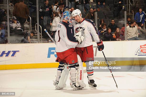 Steve Mason is congratulated by teammate Mike Commodore of the Columbus Blue Jackets for a 2-1 shutout against the Los Angeles Kings on December 29,...
