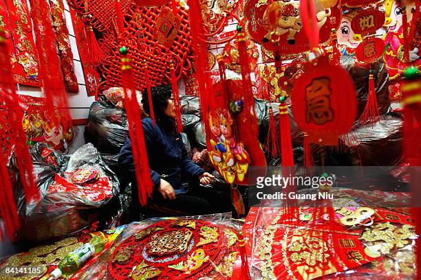 Vendor waits for customers at a New Year gifts store on December 30, 2008 in Beijing, China. The Chinese Communist Party corruption watchdog has...