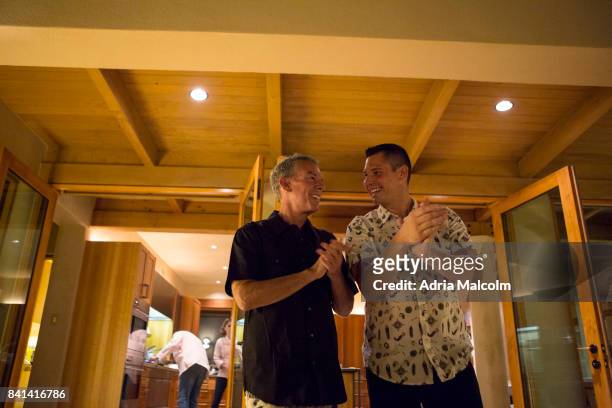 Elvis Duran and Alex Carr talk to guests at The Burning of Zozobra Pre-event Dinner hosted by the Elvis Duran at his new home in honor of Mayor...