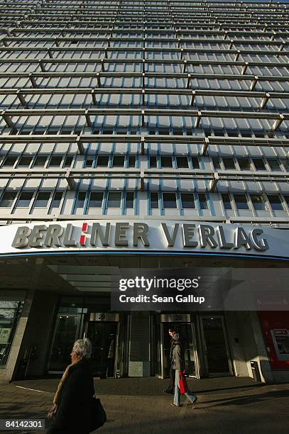 People walk past the headquarters of publisher Berliner Verlag, which owns the two daily newspapers "Berliner Zeitung" and "Berliner Kurier," on...