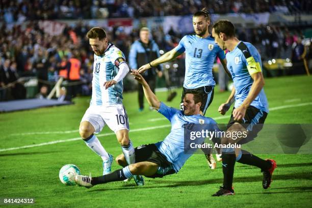 Lionel Messi of Argentina vies for the ball agains Gaston Silva and Alvaro Gonzalez of Uruguay during the 2018 FIFA World Cup qualifying match...