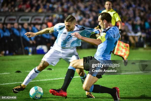 Mauro Icardi of Argentina and Diego Godin of Uruguay vie for the ball during the 2018 FIFA World Cup qualifying match between Uruguay and Argentina...