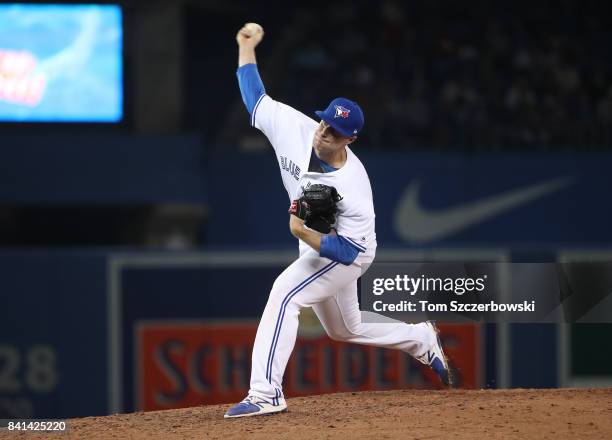 Tom Koehler of the Toronto Blue Jays delivers a pitch in the seventh inning during MLB game action against the Boston Red Sox at Rogers Centre on...