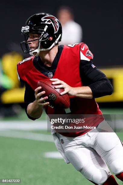 Quarterback Matt Simms of the Atlanta Falcons rolls out on a pass play during a preseason game against the Jacksonville Jaguars at Mercedes-Benz...