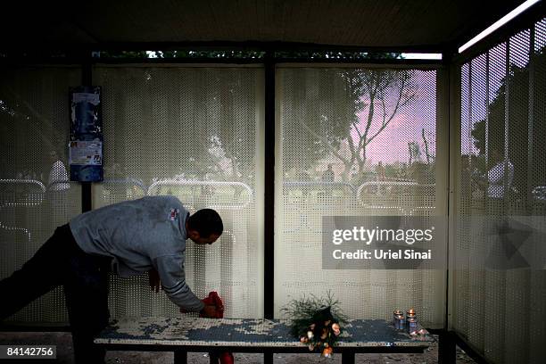 Worker cleans a bus station where Irit Shitrit mother of 4, was killed by a Hamas rocket strike yesterday, on December 30, 2008 in Ashdod about 30 KM...