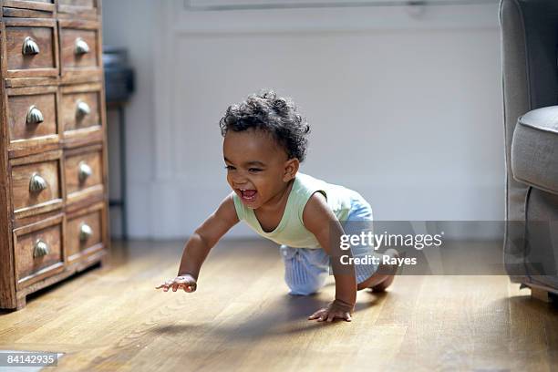 baby boy crawling and smiling - crawling stock pictures, royalty-free photos & images