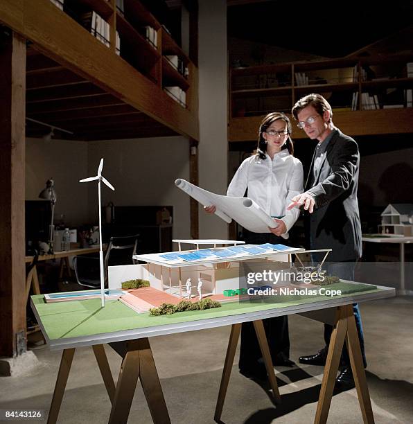 two people go over plans and architectural model. - architectural model stockfoto's en -beelden