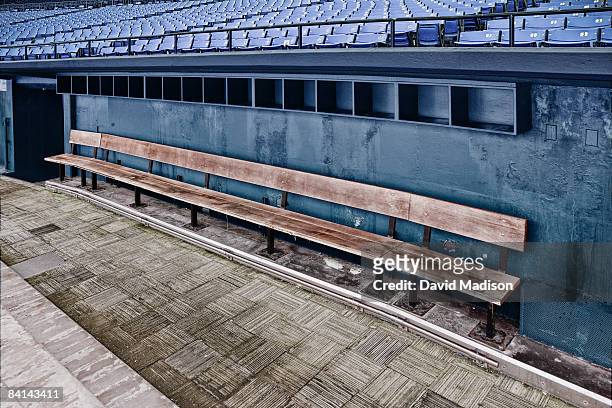 empty team bench in baseball dugout. - dugout baseball stock pictures, royalty-free photos & images