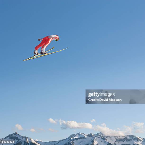 ski jumper flying through air - freestyle skiing stock-fotos und bilder