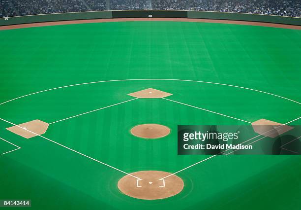 baseball field with crowd in background - base sports equipment fotografías e imágenes de stock