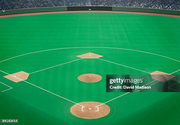 baseball field with crowd in background - baseball field background stock pictures, royalty-free photos & images