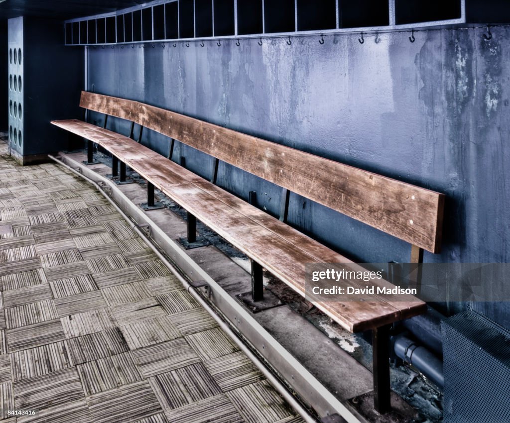 Empty team bench in baseball dugout.