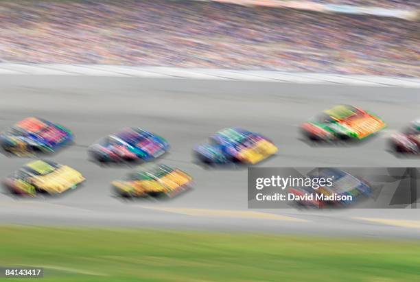 stock cars racing on track with crowd background - nascar crowd stock pictures, royalty-free photos & images