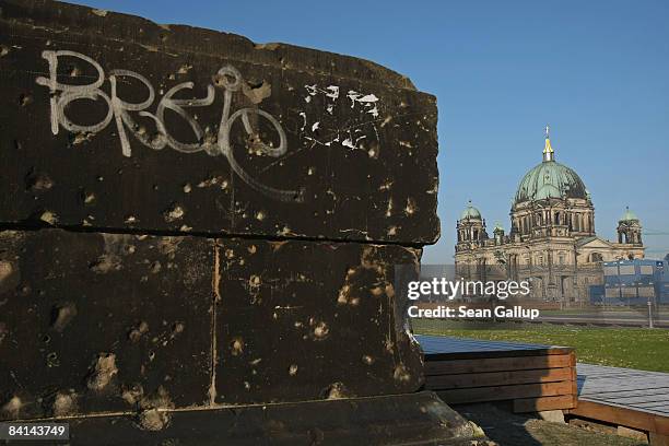 Section of a wall still pockmarked with bullet holes from World War II stands at Schlossplatz near the Berliner Dom cathedral on December 30, 2008 in...