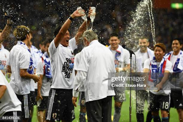 Head coach Vahid Halilhodzic and Japanese players celebrate their 2-0 victory and qualified for the FIFA World Cup Russia during the FIFA World Cup...