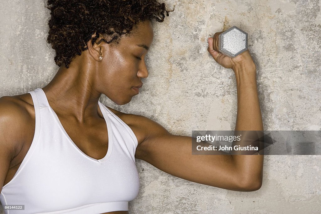 Woman exercising with dumbbell 