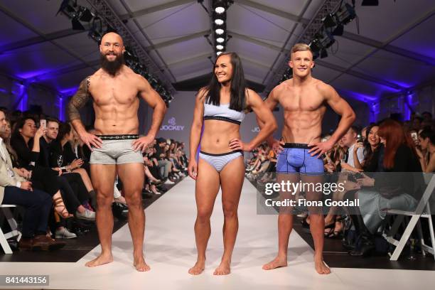 All Blacks Sevens player DJ Forbes All Black Damien McKenzie with Black Fern Portia Woodman showcasing designs by Jockey on the runway at New Zealand...