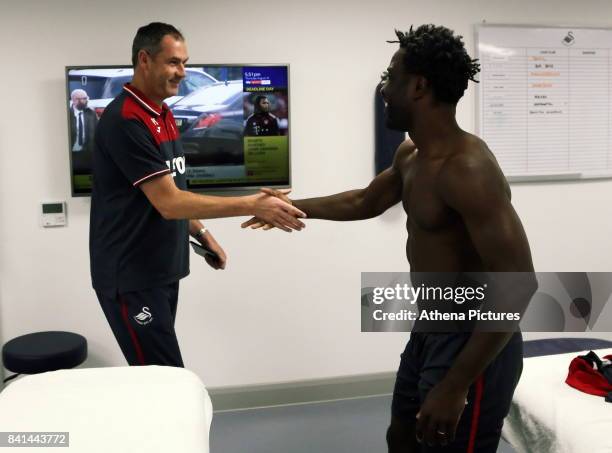 Wilfried Bony is greeted by manager Paul Clement during his medical with club physiotherapist Kate Rees at the Swansea City FC Fairwood Training...