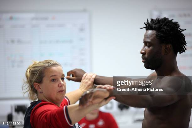 Wilfried Bony goes through his medical with club physiotherapist Kate Rees at the Swansea City FC Fairwood Training Ground on August 31, 2017 in...