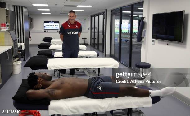 Wilfried Bony speaks with manager Paul Clement during his medical with club physiotherapist Kate Rees at the Swansea City FC Fairwood Training Ground...