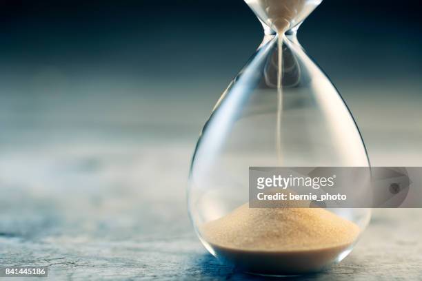 hourglass flow - clock face stock pictures, royalty-free photos & images