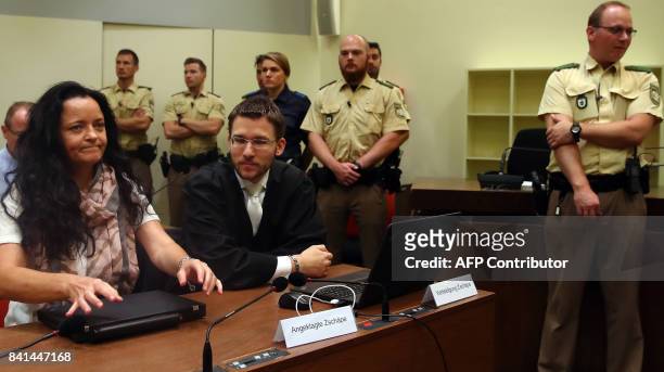 Defendant Beate Zschaepe , accused of helping to found a neo-Nazi cell called the National Socialist Underground , sits next to her lawyer Mathias...