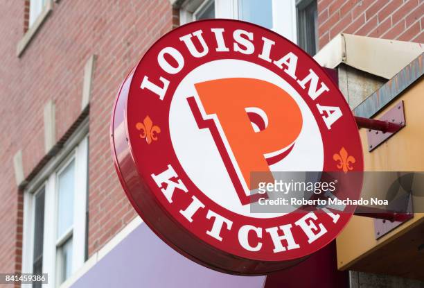 Popeyes Lousiana Kitchen sing or logo outside a restaurant wall.