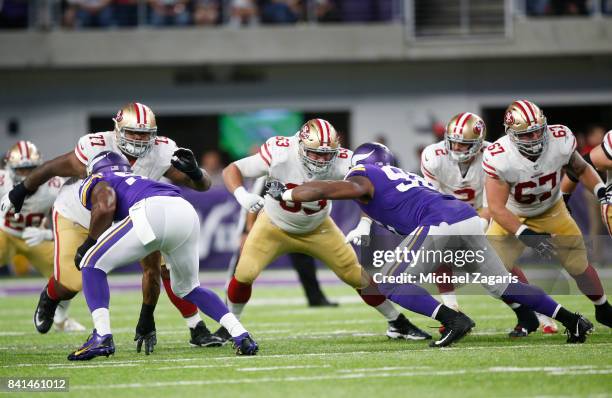 Trent Brown, Brandon Fusco and Daniel Kilgore of the San Francisco 49ers block during the game against the Minnesota Vikings at U.S. Bank Stadium on...