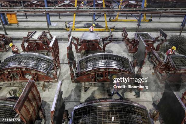 Steel reinforcing frames of precast concrete tunnel segments sit in molds at the Mumbai Metro Rail Corp. Casting yard in Mumbai, India, on Monday,...