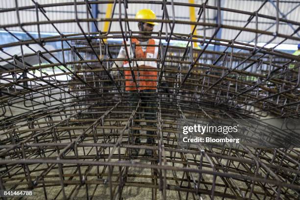The steel reinforcing frames of precast concrete tunnel segments sit stacked at the Mumbai Metro Rail Corp. Casting yard in Mumbai, India, on Monday,...