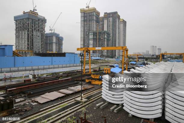 Precast concrete tunnel segments sit stacked outside at the Mumbai Metro Rail Corp. Casting yard in Mumbai, India, on Monday, Aug. 28, 2017. The...