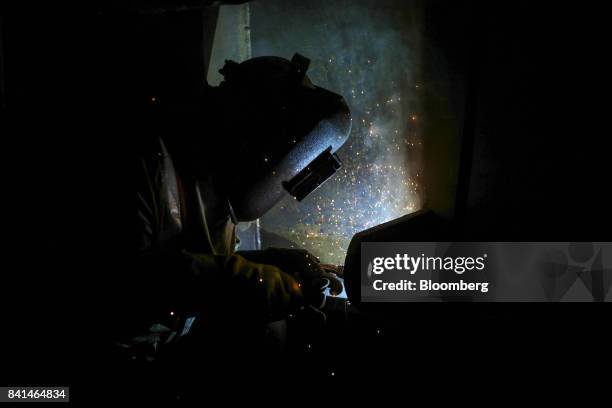 Worker welds at the Mumbai Metro Rail Corp. Casting yard in Mumbai, India, on Monday, Aug. 28, 2017. The expanding mega city's suburban railway is...