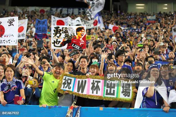 Japanese supporters celebrate their team's 2-0 victory and qualification for the FIFA World Cup Russia after the FIFA World Cup Qualifier match...