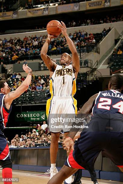 Jarrett Jack of the Indiana Pacers shoots over Mike Bibby of the Atlanta Hawks at Conseco Fieldhouse on December 30, 2008 in Indianapolis, Indiana....