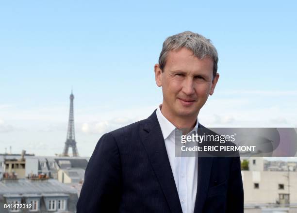 French telecom group Iliad CEO Maxime Lombardini poses for photographs prior to attending a press conference to present the group's 2017 first half...