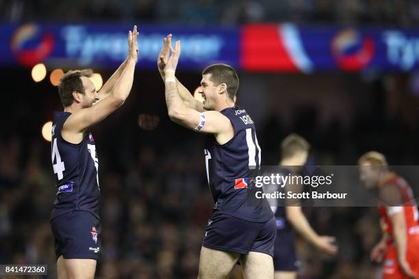 Jonathon Brown of Victoria is congratulated by Jude Bolton of Victoria after kicking a goal during the 2017 EJ Whitten Legends Game between Victoria...