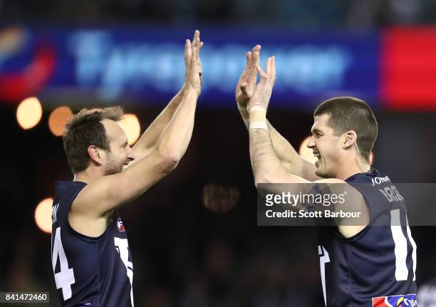 Jonathon Brown of Victoria is congratulated by Jude Bolton of Victoria after kicking a goal during the 2017 EJ Whitten Legends Game between Victoria...