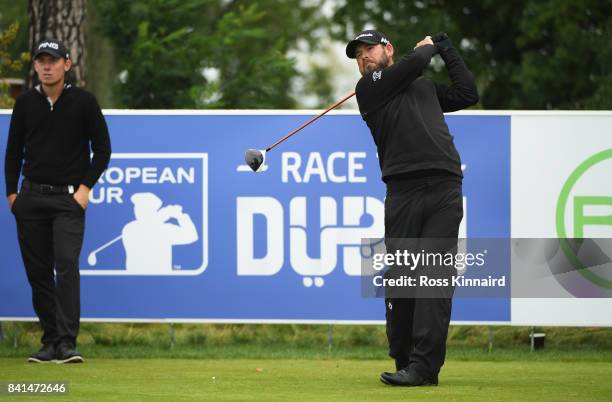 Justin Walters of South Africa tees off on the 10th hole as Anton Karlsson of Sweden looks on during day two of the D+D REAL Czech Masters at...
