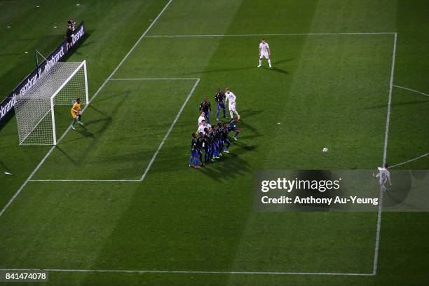 Michael McGlinchey of New Zealand shoots and scores from a free-kick against goal keeper Phillip Mango of Solomon Islands during the 2018 FIFA World...