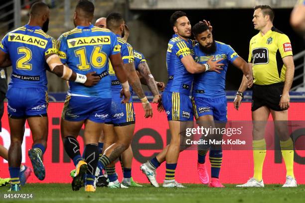 Corey Norman of the Eels congratulates team mate Michael Jennings of the Eels after scoring a try during the round 26 NRL match between the...