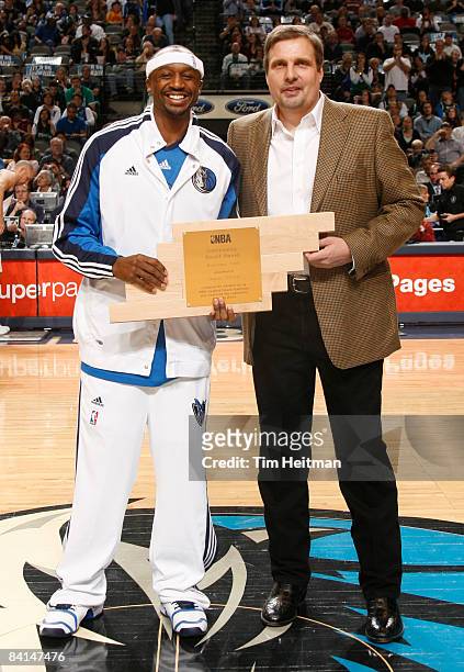 Jason Terry of the Dallas Mavericks poses with team General Manager Donnie Nelson as Terry is presented the NBA Community Assist Award prior to tip...