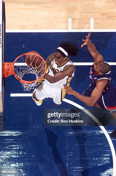 Marquis Daniels of the Indiana Pacers scores on Al Horford of the Atlanta Hawks at Conseco Fieldhouse on December 30, 2008 in Indianapolis, Indiana....