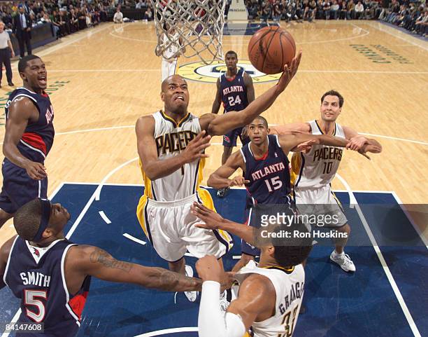 Jarrett Jack of the Indiana Pacers battles Al Horford and Josh Smith of the Atlanta Hawks at Conseco Fieldhouse on December 30, 2008 in Indianapolis,...