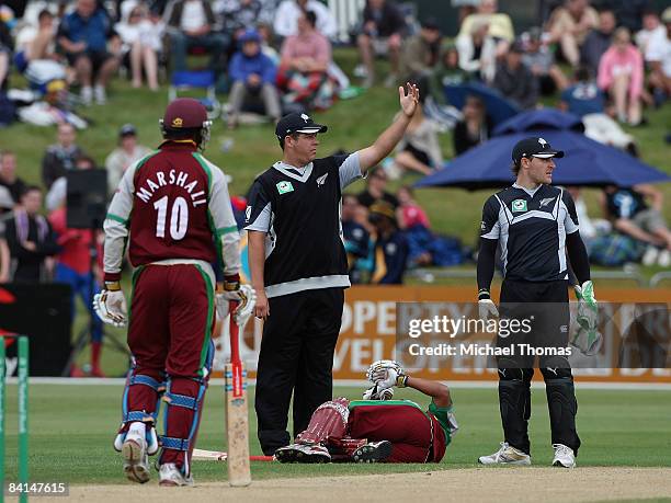 Jesse Ryder of New Zealand calls for help for the injured Ramnaresh Sarwan of the West Indies during the First One Day International Match between...