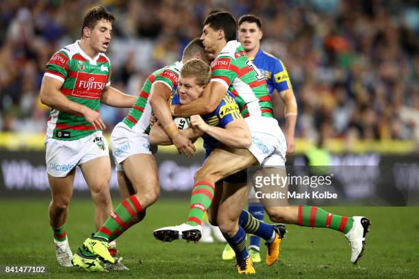 Daniel Alvaro of the Eels is tackled during the round 26 NRL match between the Parramatta Eels and the South Sydney Rabbitohs at ANZ Stadium on...