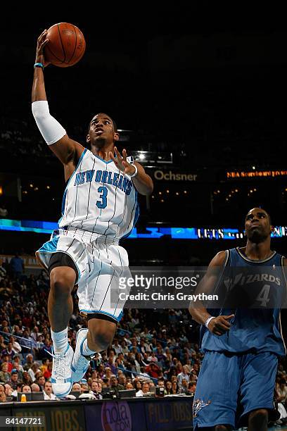 Chris Paul of the New Orleans Hornets makes a shot over Antawn Jamison of the Washington Wizards on December 30, 2008 at the New Orleans Arena in New...