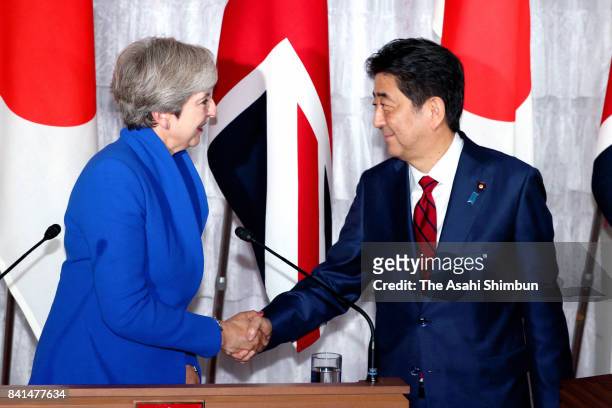 British Prime Minister Theresa May and Japanese Prime Minister Shinzo Abe shake hands during a joint press conference at Akasaka State Guesthouse on...