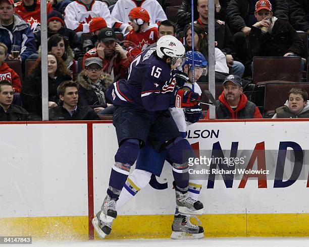 Jim O'Brien of Team USA body checks a member of a member of Team Kazakhstan during the IIHF World Junior Championships at Scotiabank Place on...